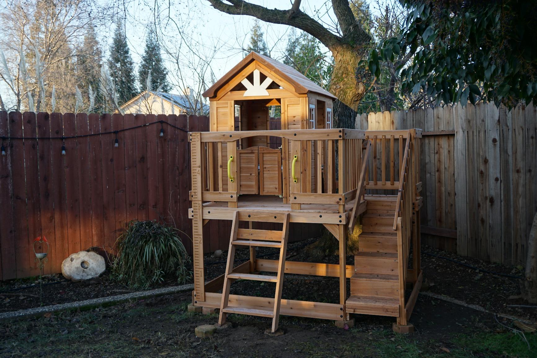 Backyard Discovery Scenic Heights Elevated Cedar Wooden Kids Playhouse with Play Kitchen, Wrap-Around Deck, Toy Storage Bench, Saloon-Style Doors, Ladder, Stairs, and Growth Chart for Outdoor Play customer photo 2